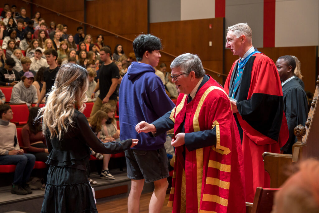 Dr Barry Craig, president of Huron University, handing out pins to first-year incoming students of the largest class to date.